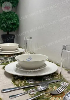 a table with a bowl and plates and silverware at Shore 2 Tower 1 - Macy's Nest - Near MOA in Manila