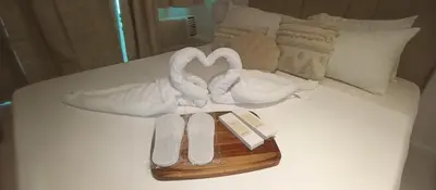 a bed with two swans made out of towels at Casa Crisav Staycation place at AZURE in Manila