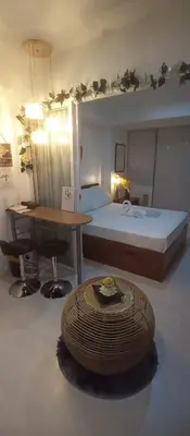 a hotel room with a bed and a table and a table sidx sidx sidx at Casa Crisav Staycation place at AZURE in Manila