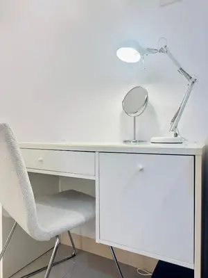 a desk with a chair and a lamp on it at Micasa at Green 2 Residences in Dasmariñas