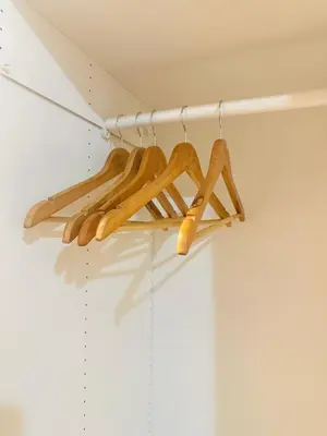 a bunch of wooden hangers in a closet at Micasa at Green 2 Residences in Dasmariñas