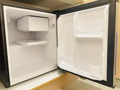 an empty refrigerator with its door open in a kitchen at Micasa at Green 2 Residences in Dasmariñas