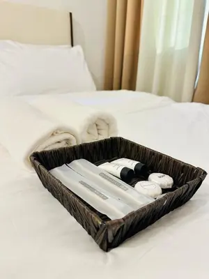 a tray of towels and toothbrushes on a bed at Micasa at Green 2 Residences in Dasmariñas
