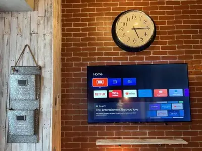 a clock on the side of a brick wall with a sign at Executive Suite 710A at S Residence by GK Condotel in Manila