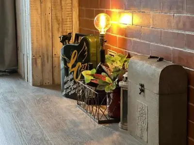 a lamp sitting on a chest next to a brick wall at Executive Suite 710A at S Residence by GK Condotel in Manila