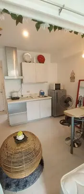 a kitchen with a table in the middle of a room at Casa Crisav Staycation place at AZURE in Manila