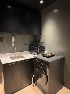 a kitchen with a washing machine and a sink at Malate Bayview Mansion 37M in Manila