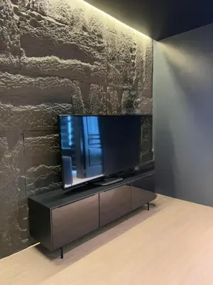 a flat screen tv sitting on a stand in a room at Malate Bayview Mansion 37M in Manila