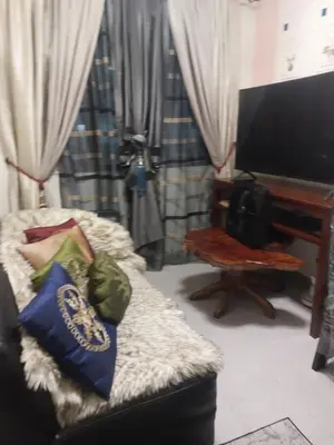 a living room with a couch and a television at Bellflower florida sun in General Trias