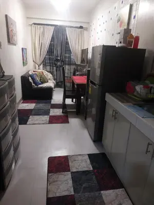 a kitchen and living room with a table and a couch at Bellflower florida sun in General Trias