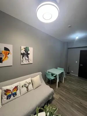 a living room with a couch and a table at Gentry Manor 2-Bed Near MOA&NAIA Okada Seaviw TV Netflix 17U in Manila