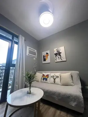 a living room with a couch and a table at Gentry Manor 2-Bed Near MOA&NAIA Okada Seaviw TV Netflix 17U in Manila