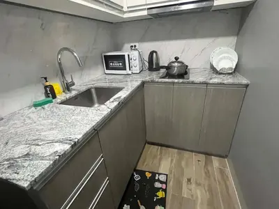 a small kitchen with a sink and a microwave at Gentry Manor 2-Bed Near MOA&NAIA Okada Seaviw TV Netflix 17U in Manila