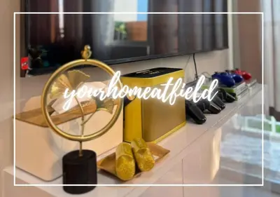 a shelf with a mirror and some shoes on it at Your HOME At Field Residences in Manila