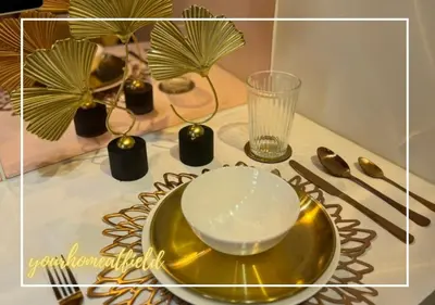 a table with a plate and a bowl and a glass at Your HOME At Field Residences in Manila