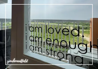a view from a window with the words i am loved at Your HOME At Field Residences in Manila
