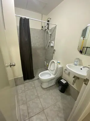 a bathroom with a toilet and a sink at The Mood Shift in Manila