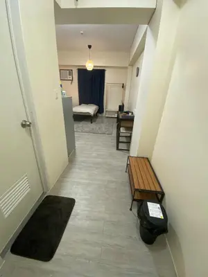 a hallway with a room with a couch and a table at The Mood Shift in Manila