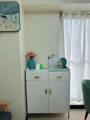 a white cabinet in a room with a window at Brixton place 2815 Weston tower in Manila