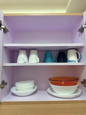 a shelf filled with plates and bowls and dishes at Brixton place 2815 Weston tower in Manila