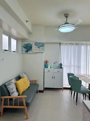 a living room with a couch and a table at Brixton place 2815 Weston tower in Manila