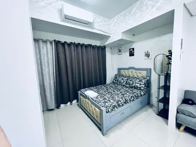 a bedroom with a bed in a room at Crisean Highrise Condo - 100 West makati in Manila