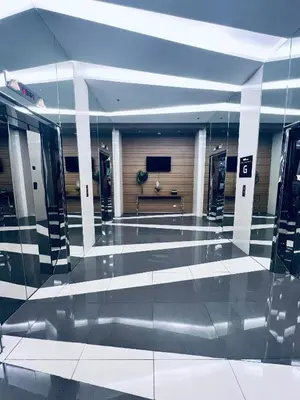 a lobby with a television in a building at Crisean Highrise Condo - 100 West makati in Manila
