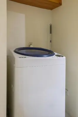 a blue sink sitting on top of a refrigerator at Forbeswood Heights 1Br with Garden view in Manila