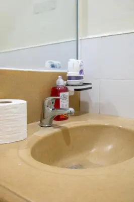 a sink with a faucet in a bathroom at Forbeswood Heights 1Br with Garden view in Manila
