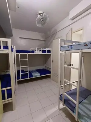a room with three bunk beds and a ceiling at City Space in Manila