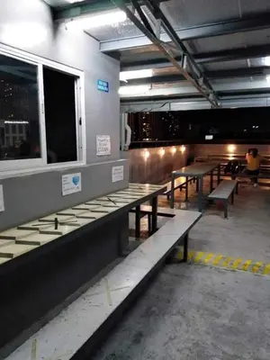 a row of benches in a building with tables at City Space in Manila