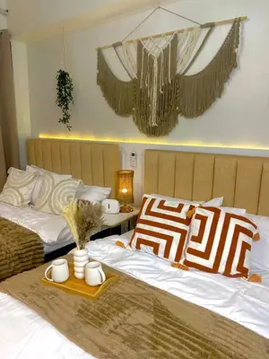 two beds in a bedroom with two mugs on them at Cozy Vibes near MOA & NAIA AIRPORT with NETFLIX,MINIVIDEOKE,BOARDGAMES-DUXE4 in Manila