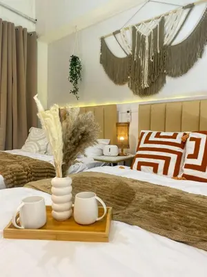 a bedroom with two beds and a tray with two mugs at Cozy Vibes near MOA & NAIA AIRPORT with NETFLIX,MINIVIDEOKE,BOARDGAMES-DUXE4 in Manila