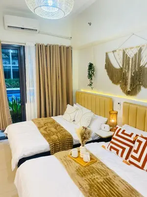 a bedroom with two beds and a table with cups on it at Cozy Vibes near MOA & NAIA AIRPORT with NETFLIX,MINIVIDEOKE,BOARDGAMES-DUXE4 in Manila