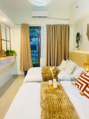 a hotel room with two beds and a window at Cozy Vibes near MOA & NAIA AIRPORT with NETFLIX,MINIVIDEOKE,BOARDGAMES-DUXE4 in Manila