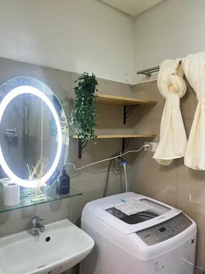 a bathroom with a washing machine and a sink at Cozy Vibes near MOA & NAIA AIRPORT with NETFLIX,MINIVIDEOKE,BOARDGAMES-DUXE4 in Manila