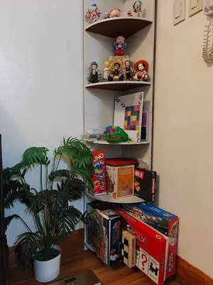 a room with shelves filled with toys and a plant at Serenity Escapes by Aj in Manila