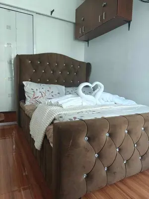 a bed with two swans on top of it at Serenity Escapes by Aj in Manila