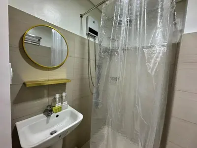a bathroom with a shower with a sink and a mirror at 726 Shore 2 Residences near SM MOA & IKEA by Prime Stay in Manila