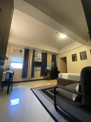 a bedroom with a bed and a couch and a table at A&G Condotel at 101newport Near NAIA T3 in Manila