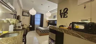 a room with a kitchen and a living room at A&G Condotel at 101newport Near NAIA T3 in Manila