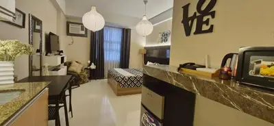 a room with a kitchen and a living room at A&G Condotel at 101newport Near NAIA T3 in Manila