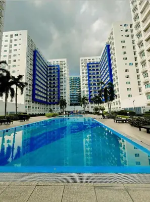 a large swimming pool in front of some buildings at Sea Residences Briella's Staycation in Manila