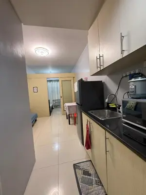 a kitchen with a sink and a counter top at Sea Residences Briella's Staycation in Manila