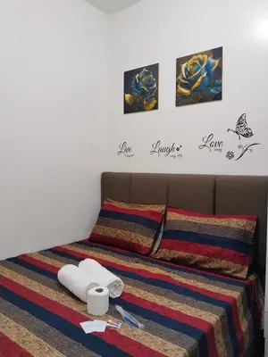 a bedroom with a bed with towels on it at Dhayz Staycation in Manila