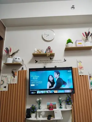 a flat screen tv hanging on a wall at Dhayz Staycation in Manila