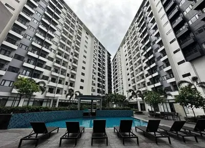 a group of chairs sitting in front of tall buildings at Dhayz Staycation in Manila