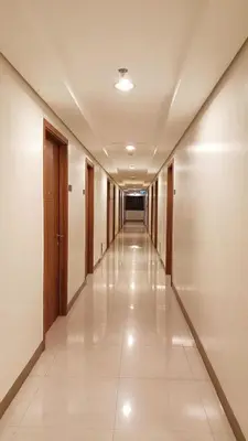 an empty corridor in a building with a long hallway at Dhayz Staycation in Manila