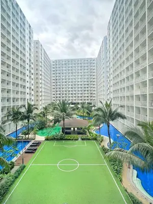 a tennis court in front of a large building at Shore Residences 2 Bedroom Near NAIA Airport and MOA in Manila