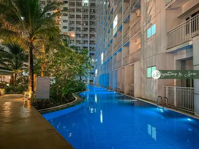 a swimming pool in the middle of a building at Shore Residences 2 Bedroom Near NAIA Airport and MOA in Manila